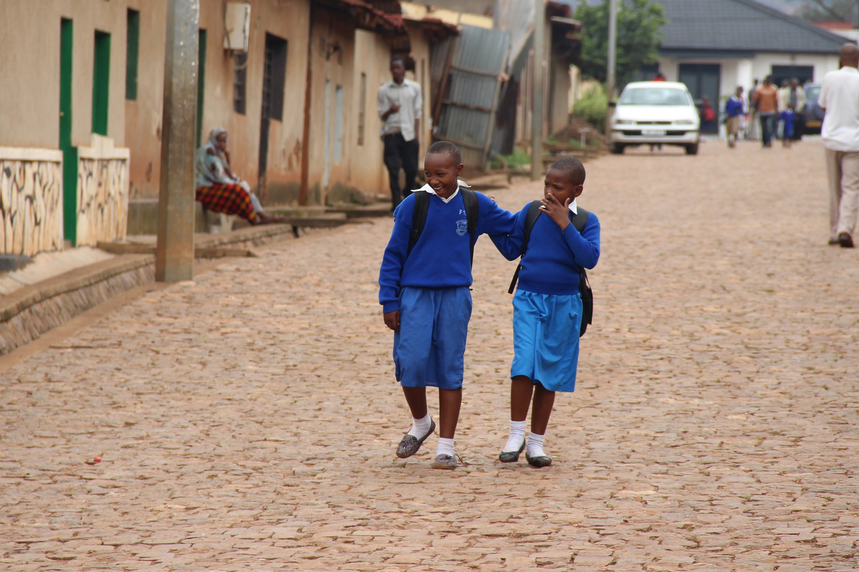 Shutterstock: KIGALI, RWANDA - CIRCA JULY 2016: Two young school girls in uniform on their way home after class.