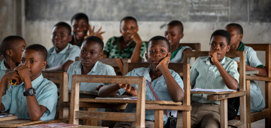 Shutterstock / James Dalrymple. Ho, Asogli, Ghana - September 15, 2018: Ghanaian school children listen patiently to a lesson in class.